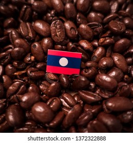 A Laos Flag Placed Over Roasted Coffee Beans