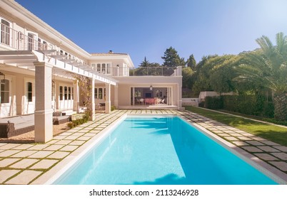 Lap swimming pool along luxury house - Shutterstock ID 2113246928