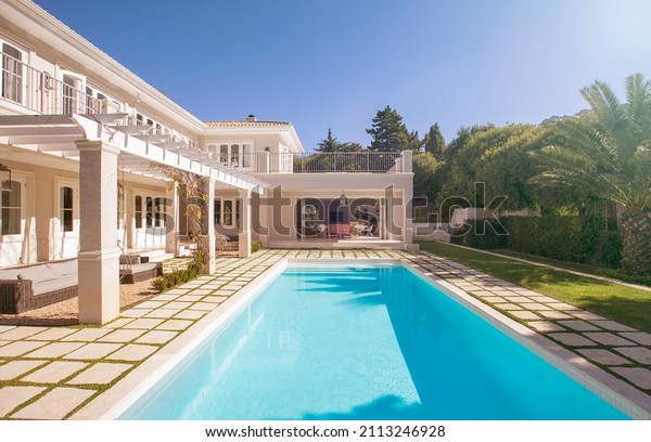 Lap swimming pool along\
luxury house