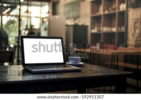 Lap top on wood table in coffee shop