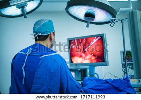 A laparoscopic surgeon at work, performing a minimally invasive surgery using a 3mm mini-laparoscopic equipment