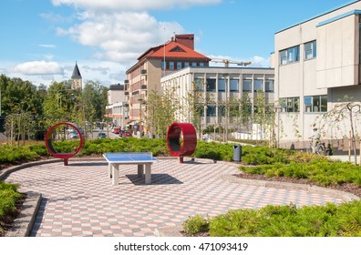 LAPPEENRANTA, FINLAND - AUGUST 8, 2016: Tennis Table And Round Red Benches Near Monari Youth Community Center And City Library