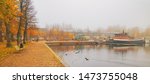Lappeenranta port with boat at autumn day. Sights of Lappeenranta harbor and garden, beautiful fall tree yellow leaves amazing view. October autumn park foliage and lake fog scene, travel in Finland
