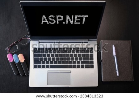 Laptop with ASP.Net text. Top view. ASP.Net inscription on laptop screen.