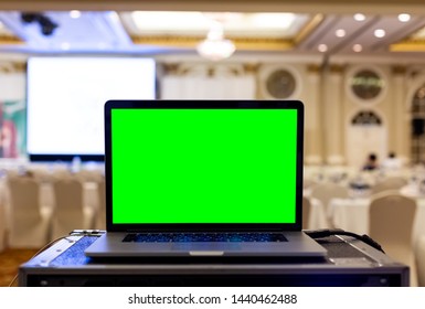 Laptop With Blank Green Screen In Seminar Room.