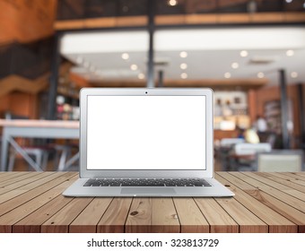 Laptop with blank screen on cafe background.