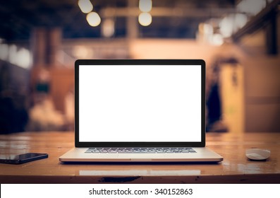 Laptop with blank screen on table.