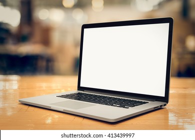 Laptop with blank screen on table - whole laptop is sharp.