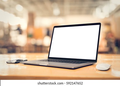 Laptop with blank screen on table in angled position - Shutterstock ID 592147652