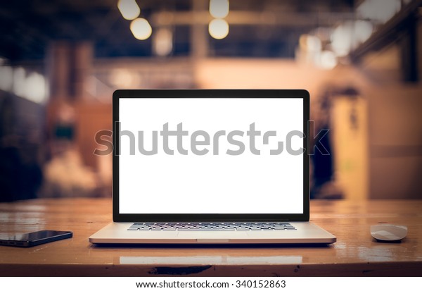 Laptop with blank screen on\
table.