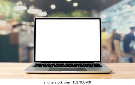 Laptop blank screen on wood table with coffee cafe background, mockup, template for your text, Clipping paths included for background and device screen - Powered by Shutterstock