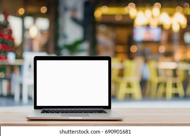 Laptop With Blank Screen On Wood Table And Coffee Shop Background.