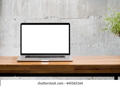 laptop blank screen on wooden table with concrete wall background