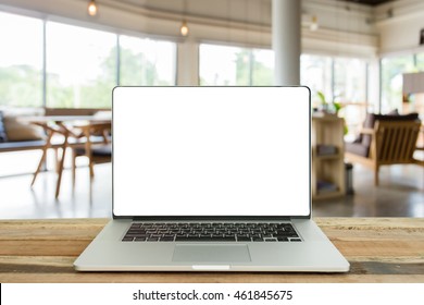 laptop with blank screen over wooden table indoor and blurred background - Shutterstock ID 461845675