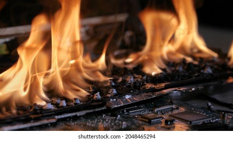 Laptop Burning In Flames On A Desk, Fire Hazard. Losing Valuable Data, Closeup