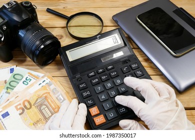 laptop, calculator, digital camera and money, store selling photographic equipment, pawnshop concept, closeup