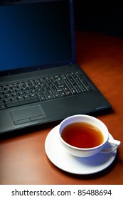 Laptop and a cap of tea