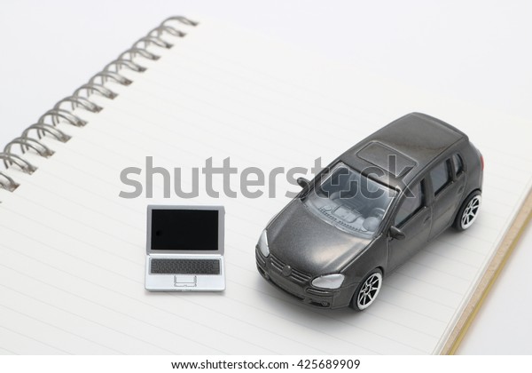Laptop and car.\
Miniature notebook PC and car\
on notebook.