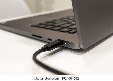 The Laptop Is Charged From The Power Supply Via A Cable