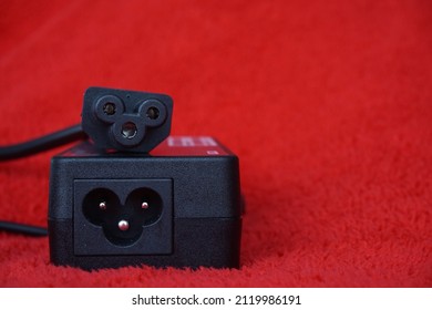 Laptop Charger Isolated On Red Background