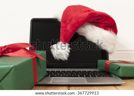 laptop, christmas presents and santa cap