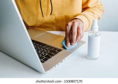 Laptop cleaning up. Service for cleaning notebook screen, keyboard, case. Cleaning accessories: brush, cloth, spray. Computer monitor, display care. Professional service, clean up. Man who wipe laptop - Powered by Shutterstock