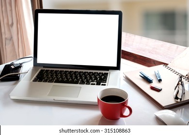 Laptop with coffee cup home office.
