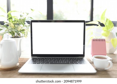 Laptop and coffee cup and mini calendar - Powered by Shutterstock