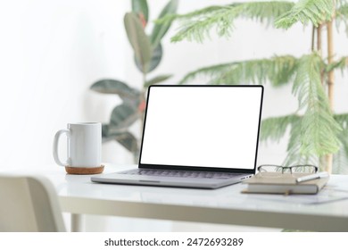 Laptop, coffee cup and notebook on white table. Empty screen for your advertise design. - Powered by Shutterstock