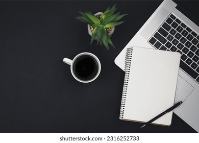 Laptop, coffee cup and notepad on black background, top view. - Powered by Shutterstock