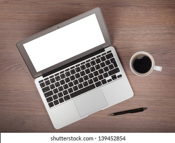 Laptop And Coffee Cup On Wood Table. View From Above