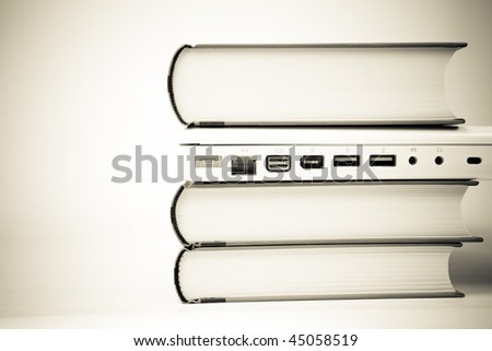laptop computer between books