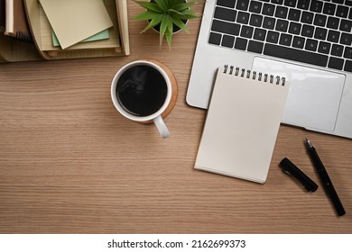 Laptop Computer, Blank Notepad, Pen And Coffee Cup On Wooden Tale. Flat Lay, Top View