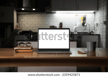 laptop computer blank screen on work table at night time