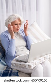 Laptop Computer Broke In Elderly Woman. Frustrated Lady Looking Disappointed By New Computer Technologies.