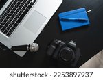 Laptop computer, camera, microphone, and notebook on a journalist