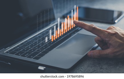 Laptop or computer with chart. Investment in business and financial concept of growth and success. Investor data analysis for planning in strategy of stock market fund. Invest for earning or profit. - Shutterstock ID 1978695896