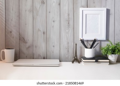 Laptop Computer, Coffee Cup, Houseplant And Stationery On White Table.