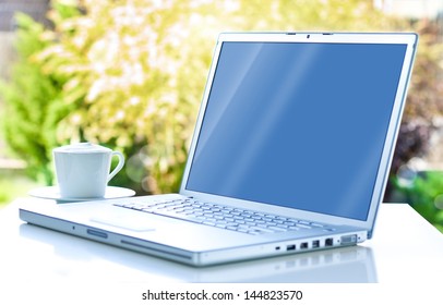 Laptop Computer And Coffee In The Garden - Freelance Or Remote Work Concept