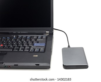 Laptop computer connected to external USB hard drive for extra storage and capacity