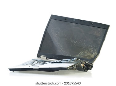 Laptop computer destroyed beyond repair in a car accident. Isolated on white background