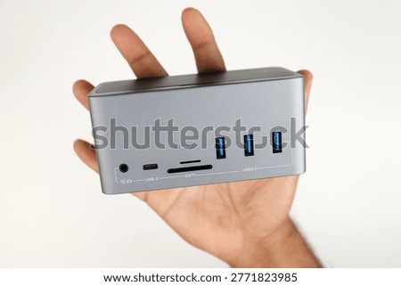 A Laptop or Computer Docking Station in Hand with USB and Type C ports isolated in white Background (Connectivity Concept)