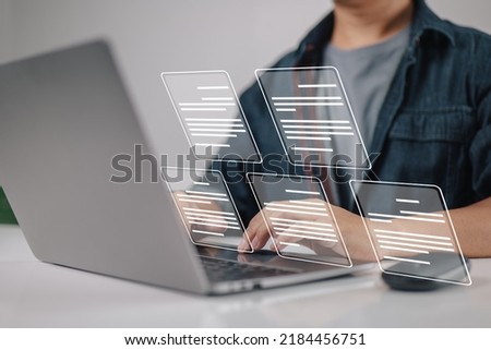 Laptop computer with electronic document icons, E-document management, an online documentation database, and the notion of a paperless workplace in mind for a businessman.
