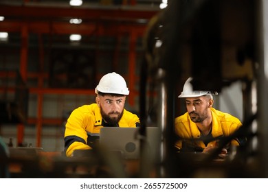 laptop computer : engineer worker working control sheet metal roof machine at metal sheet profiling factory. Industrial production. Service and Maintenance of factory machinery
