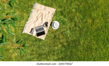 Laptop Computer And Headphones On Park Green Grass, Working And Studying Online Outdoors, Work Outside Office Concept, Aerial Top View From Above