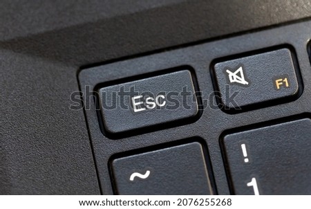 Laptop computer keyboard Esc, escape key macro detail, top view, object extreme closeup, from above, nobody. Stop, no, quit, cancel, abort key, escape sequence character, aborting and halting concept