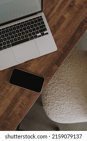 Laptop Computer, Mobile Phone On Wooden Table And Chair. Top View Minimalist Aesthetic Luxury Bohemian Workspace. Flatlay