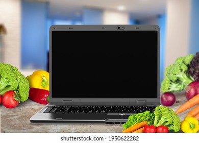 Laptop Computer With Mockup White Screen And Vegetarian Healthy Food On The Desk