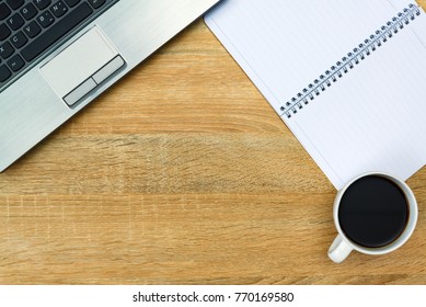 Laptop computer or notebook, note and cup of coffee  on working table or desk, work space with copy space top view.