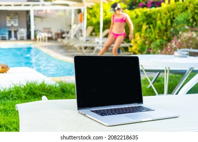 laptop computer on table pool background